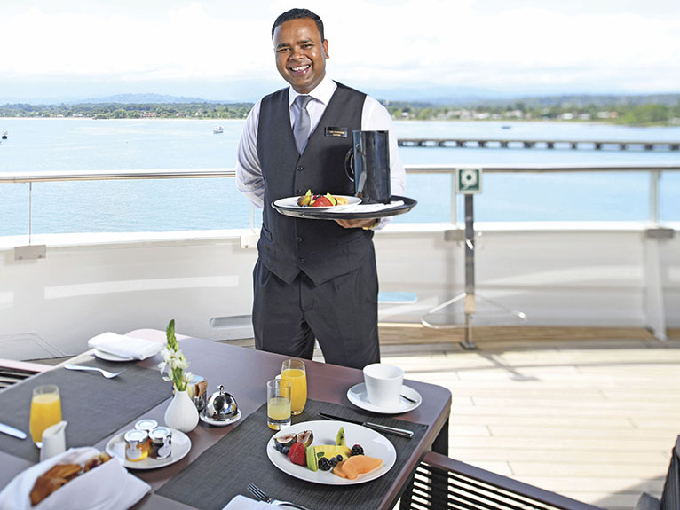 Butler serving breakfast on the Scenic Eclipse