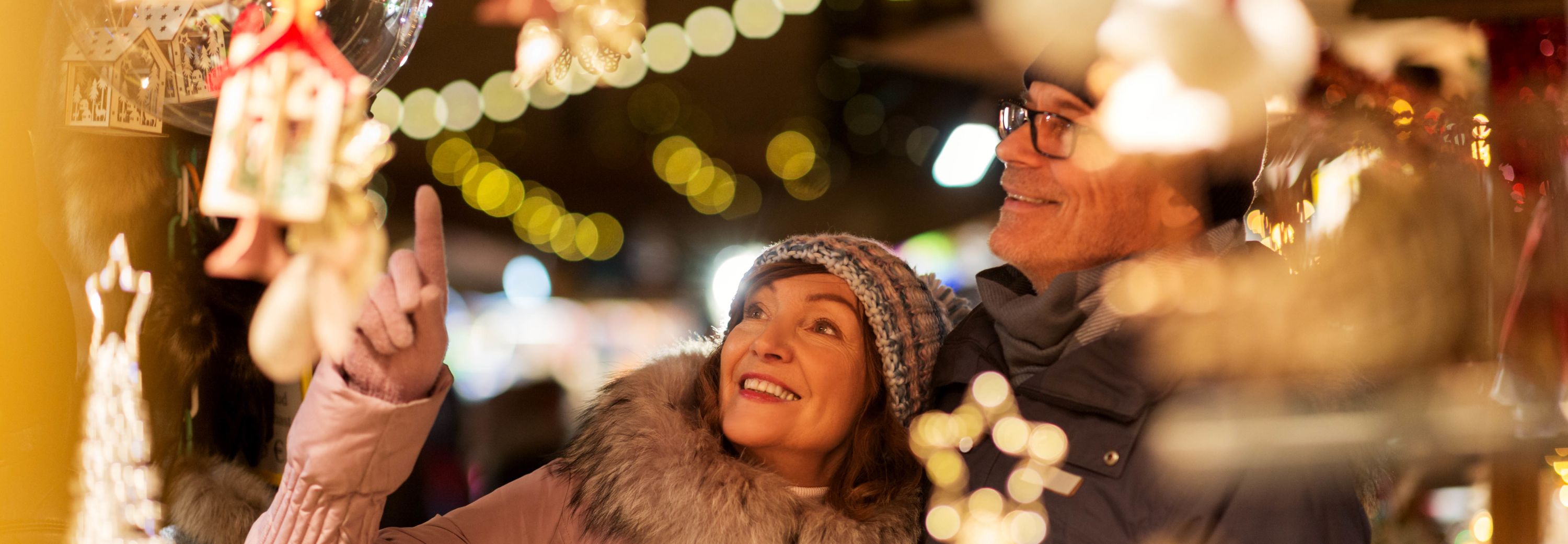 Couple looking at Christmas decorations at a Christmas market