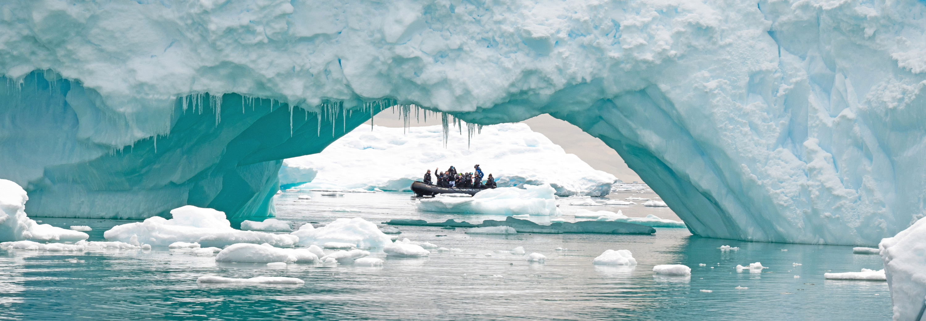 Looking through an arch-shaped ice berg to ice field beyond
