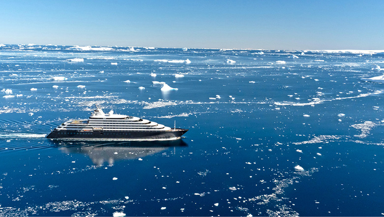 Luxury yacht "Scenic Eclipse I" sailing through Lemaire Channel in Antarctica.